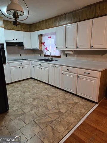 a kitchen with cabinets a sink and dishwasher