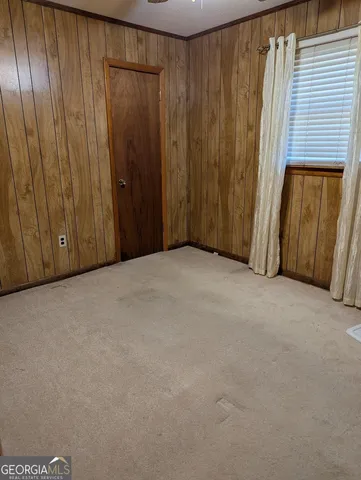 a view of a closet with wooden walls