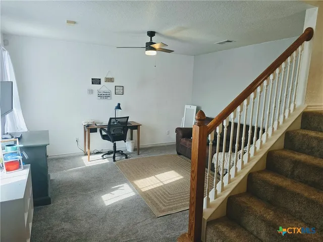a workspace with furniture staircase and a living room