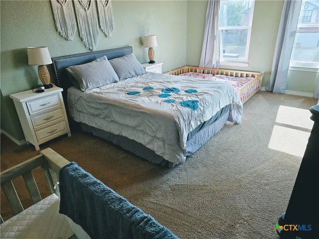 a bedroom with a bed and window