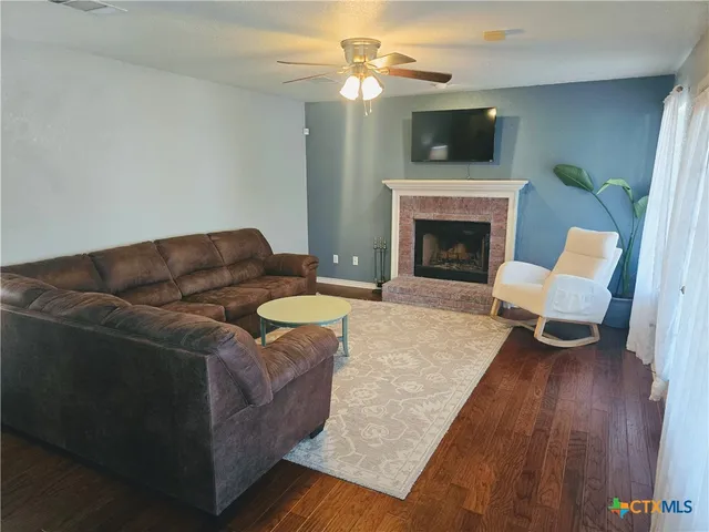 a living room with furniture and a fireplace