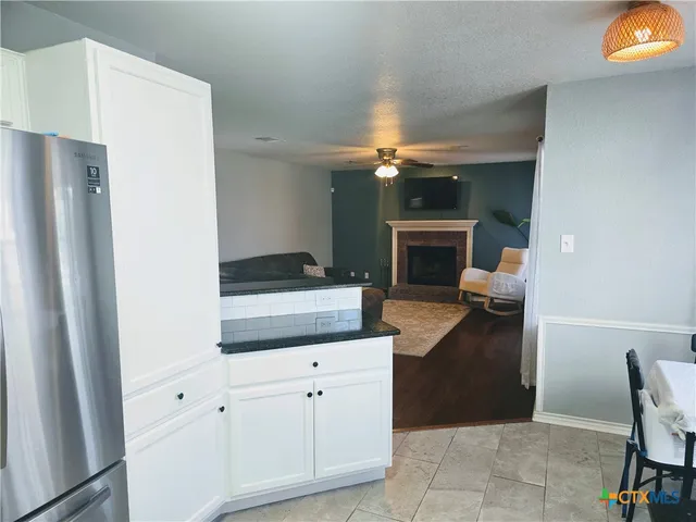 a kitchen with a refrigerator and a stove top oven