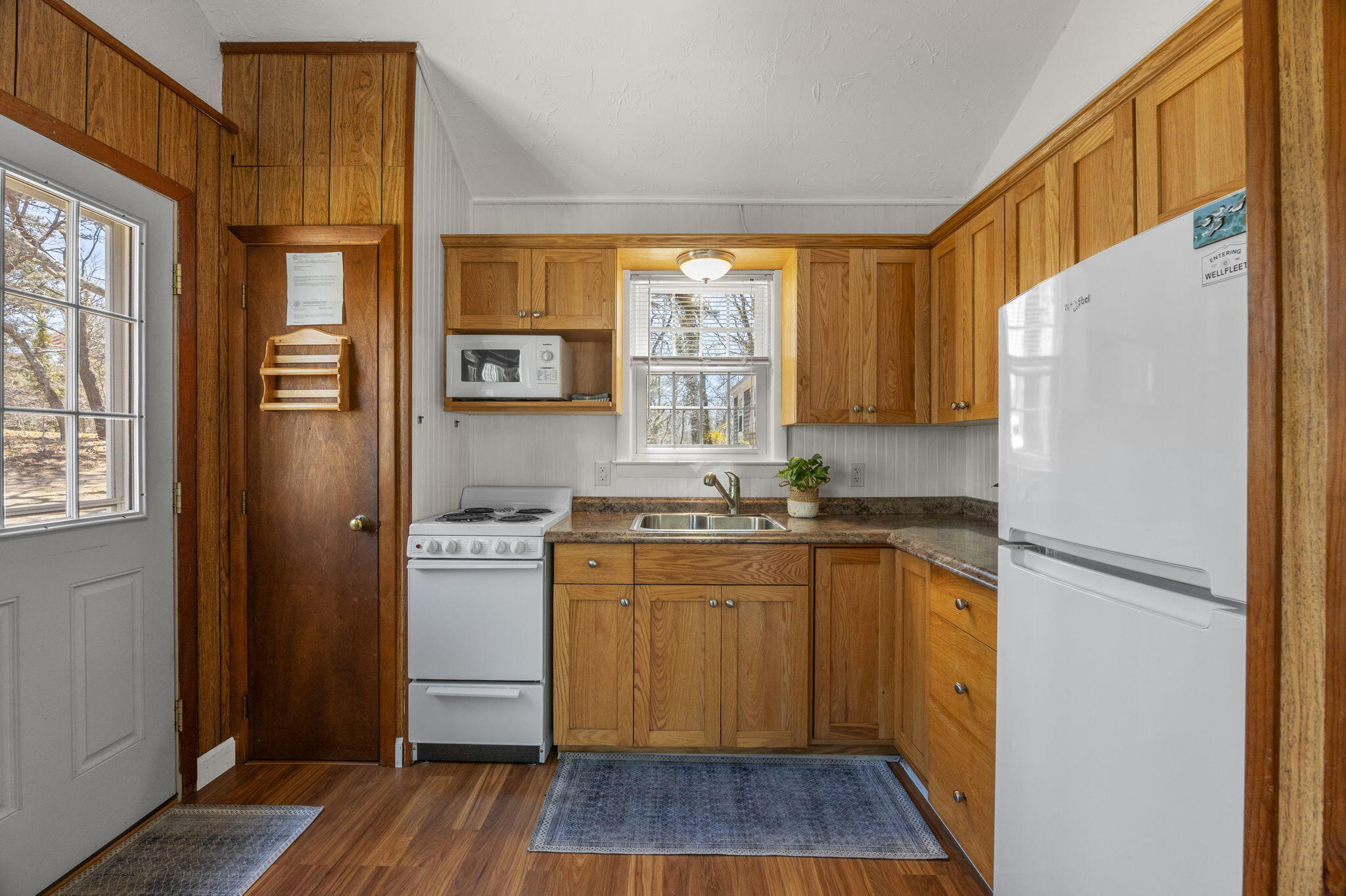 60 Long Avenue, Unit A Wellfleet, MA 02667 - Photo 5 of 28 a kitchen with stainless steel appliances granite countertop a refrigerator and a sink