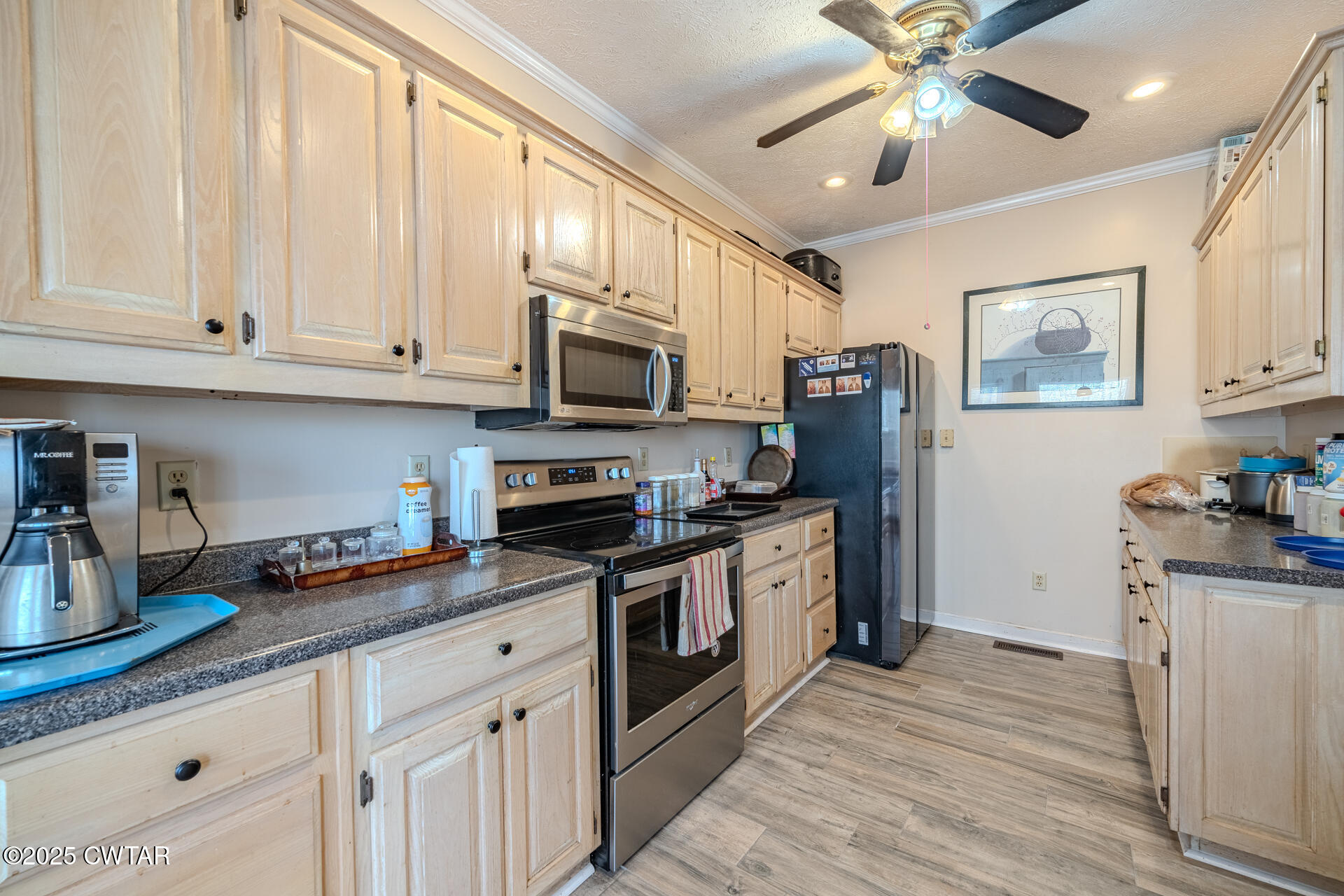 43 Paddock Place Jackson, TN 38305 - Photo 11 of 38 a kitchen with stainless steel appliances granite countertop a stove a sink and a refrigerator