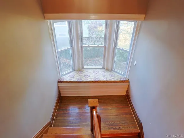 a room with wooden floor and window