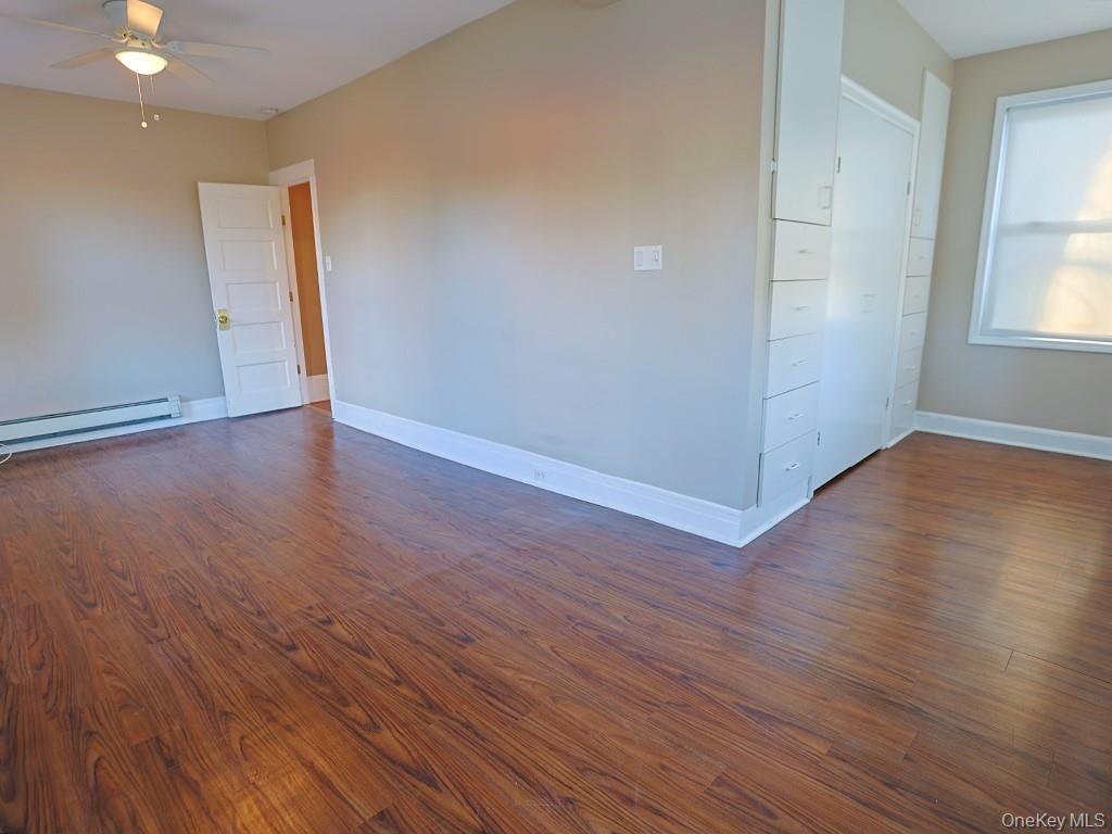 113 Hooker Avenue Poughkeepsie, NY 12601 - Photo 14 of 49 Empty room featuring dark wood finished floors and a ceiling fan