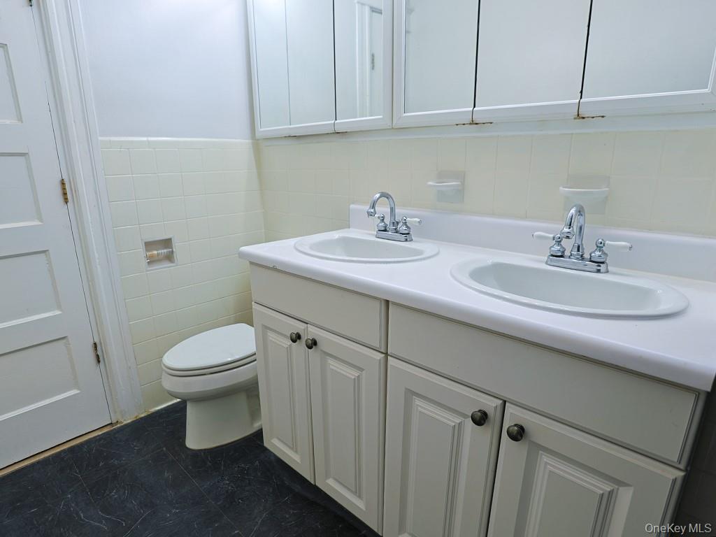 113 Hooker Avenue Poughkeepsie, NY 12601 - Photo 16 of 49 Full bathroom featuring tile walls and double vanity