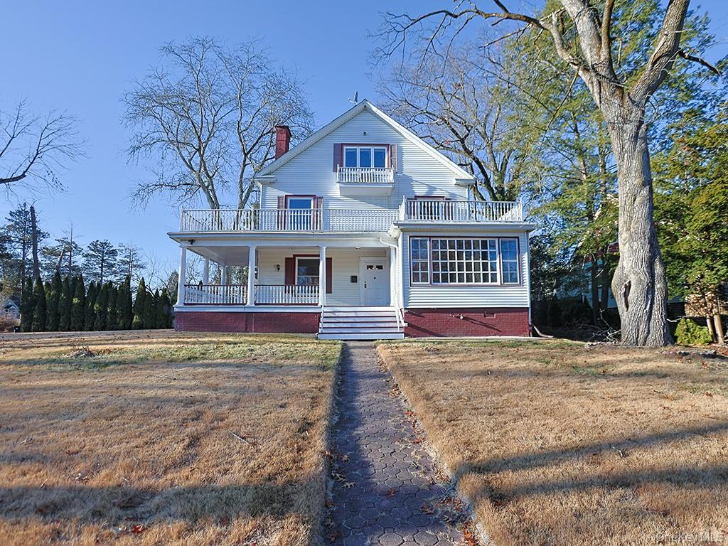 113 Hooker Avenue Poughkeepsie, NY 12601 - Photo 2 of 49 View of front of house with covered porch, a chimney, a front lawn, and a balcony