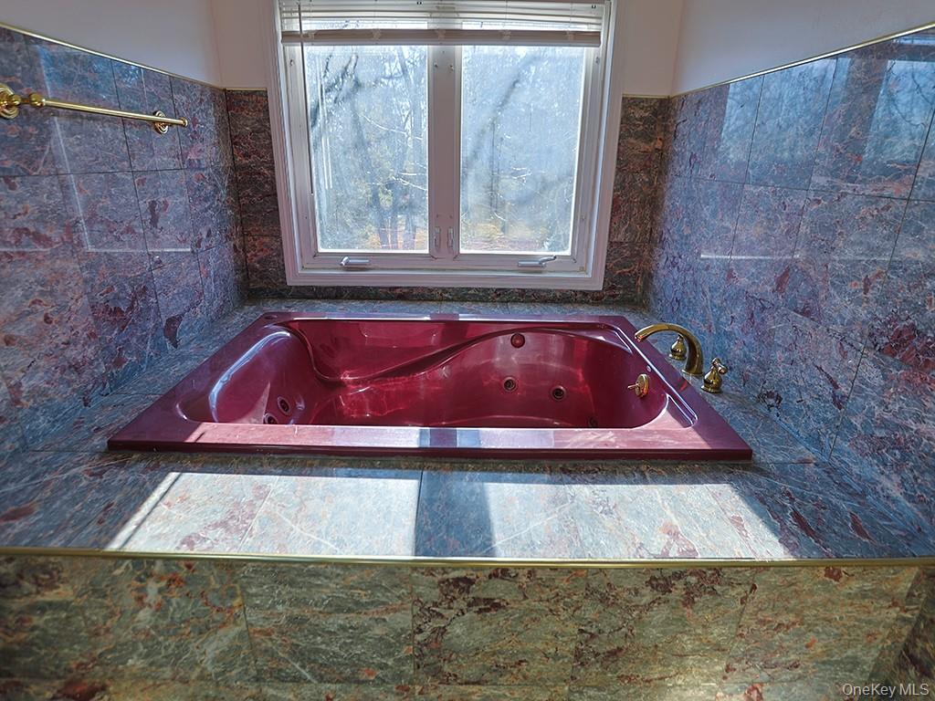 113 Hooker Avenue Poughkeepsie, NY 12601 - Photo 27 of 49 Full bath featuring a jetted tub and tile walls