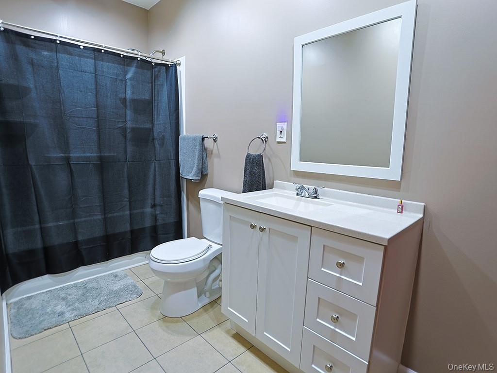 113 Hooker Avenue Poughkeepsie, NY 12601 - Photo 48 of 49 Bathroom featuring vanity and light tile patterned floors