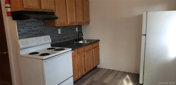 a kitchen with sink and cabinets