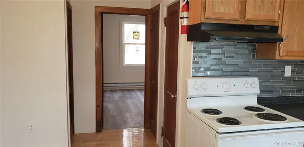 a kitchen with a refrigerator and a stove top oven