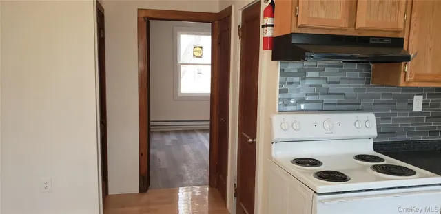 a kitchen with a refrigerator and a stove top oven