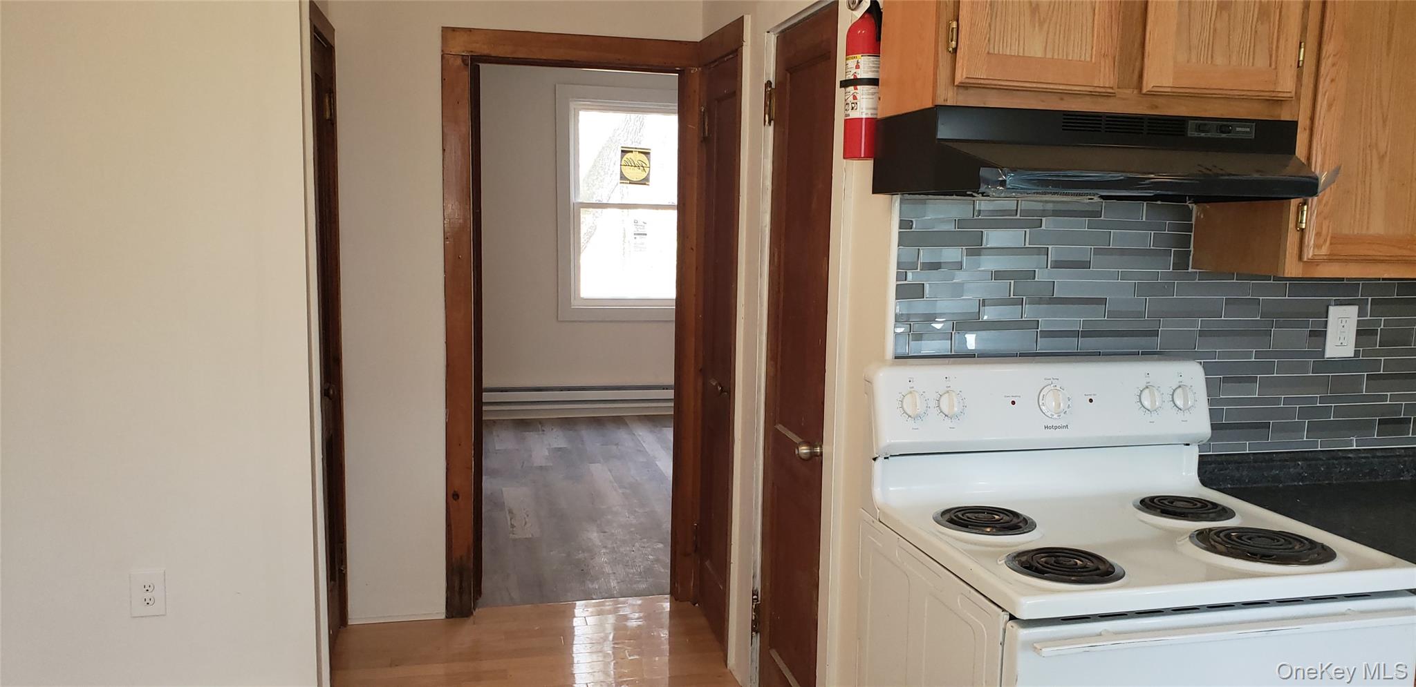 42 Hillside Avenue Monticello, NY 12701 - Photo 3 of 12 a kitchen with a refrigerator and a stove top oven