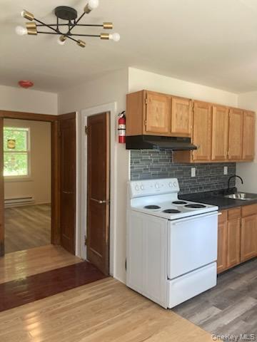 42 Hillside Avenue Monticello, NY 12701 - Photo 5 of 12 a kitchen with stainless steel appliances granite countertop a stove and a refrigerator