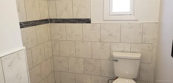 a bathroom with a window and a shower