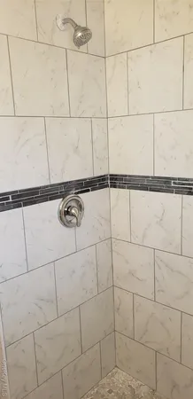 a bathroom with a shower and a shower