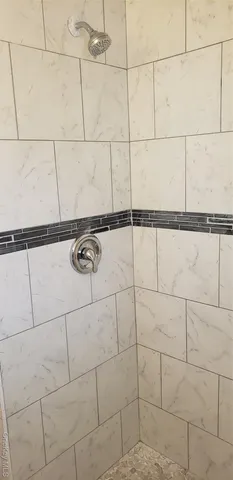 a bathroom with a shower and a shower