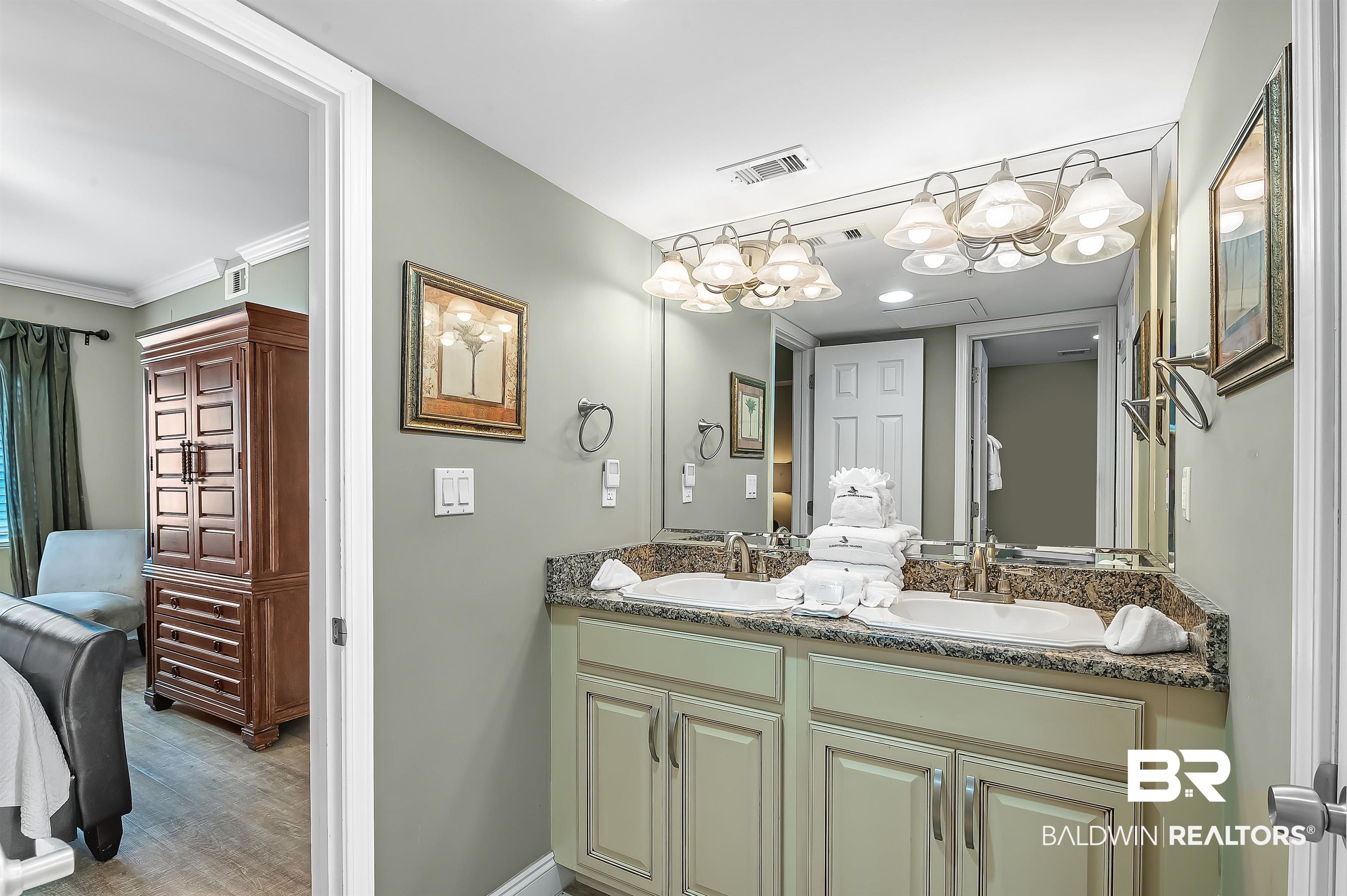 16287 Perdido Key Drive, Unit 105 Pensacola, FL 32507 - Photo 31 of 66 Bathroom featuring a double vanity with granite-style countertops, dual undermount sinks, and a full-width wall mirror