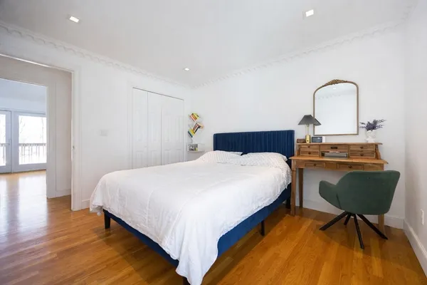 a bedroom with a bed and a chair