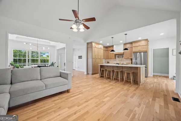 a kitchen with stainless steel appliances granite countertop a sink a stove and a refrigerator