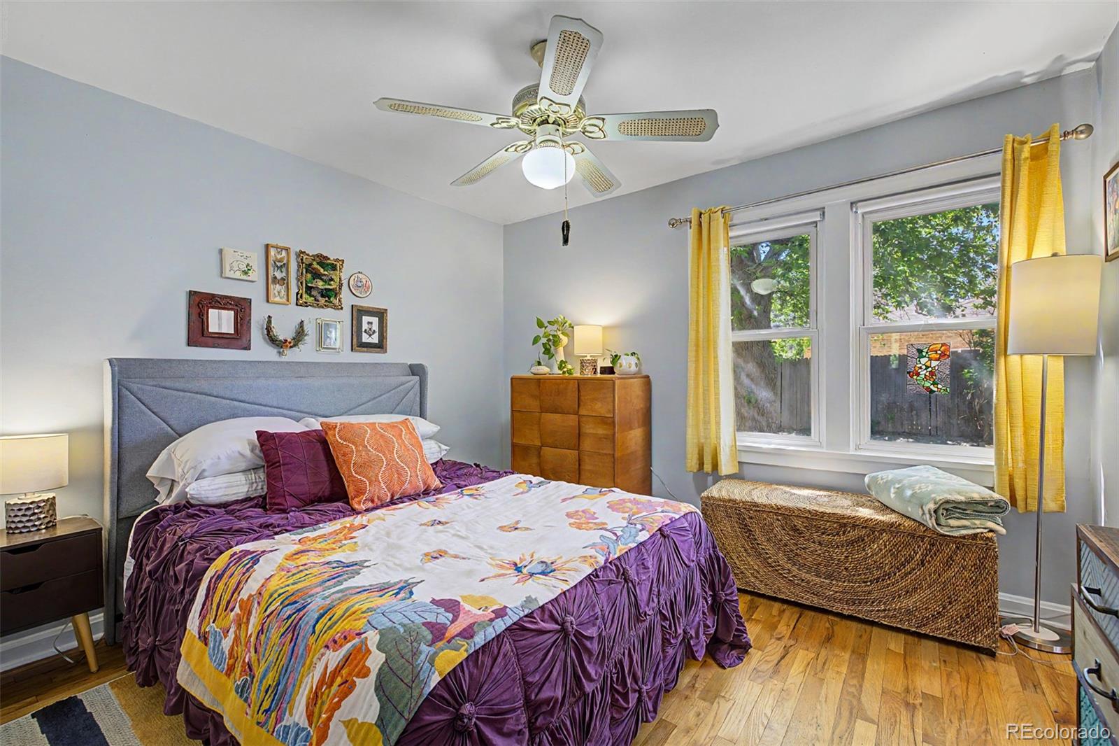 6790 West 48th Avenue Wheat Ridge, CO 80033 - Photo 15 of 30 a bedroom with a large bed and a chandelier