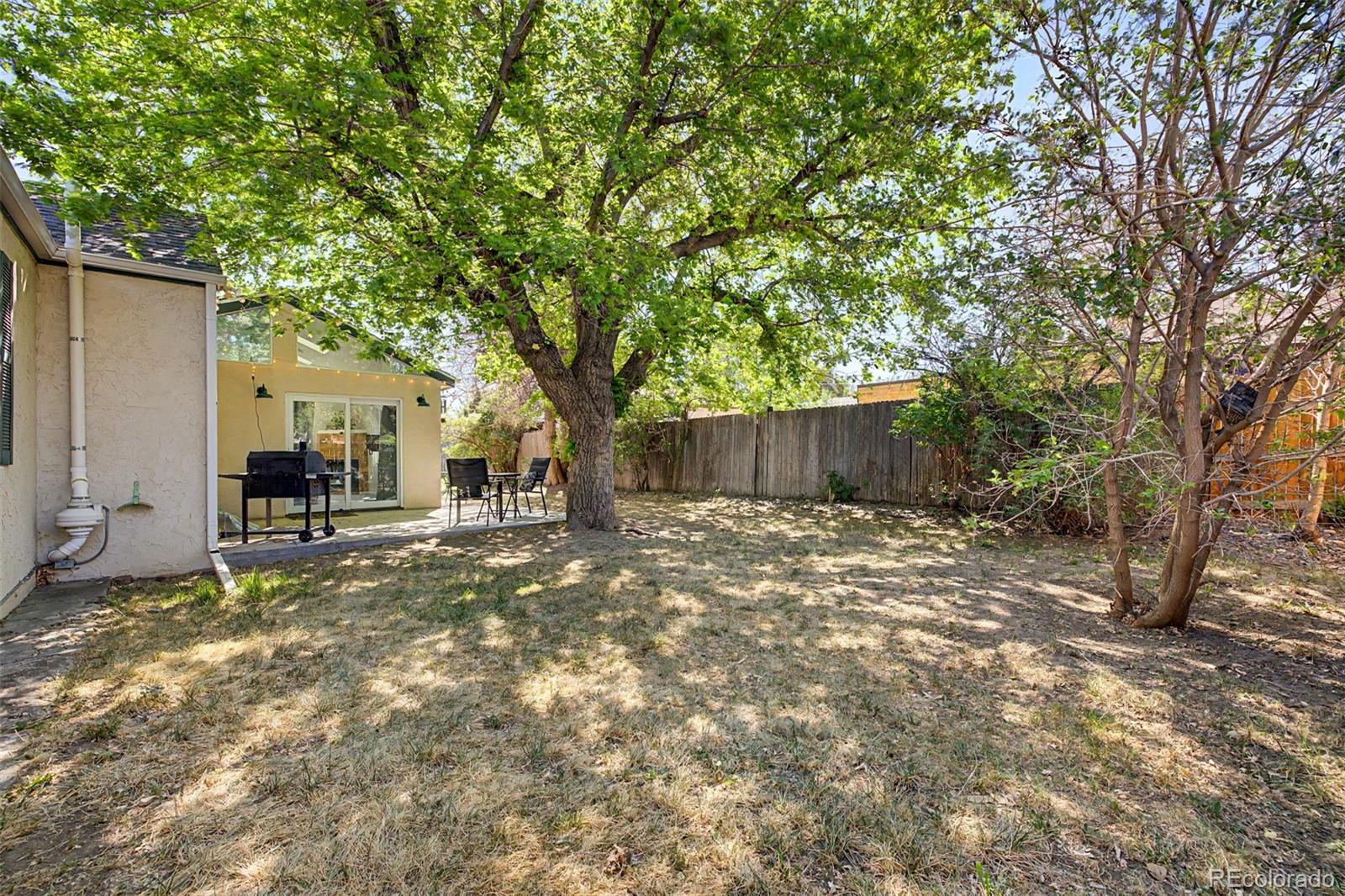 6790 West 48th Avenue Wheat Ridge, CO 80033 - Photo 27 of 30 a backyard of a house with table and chairs