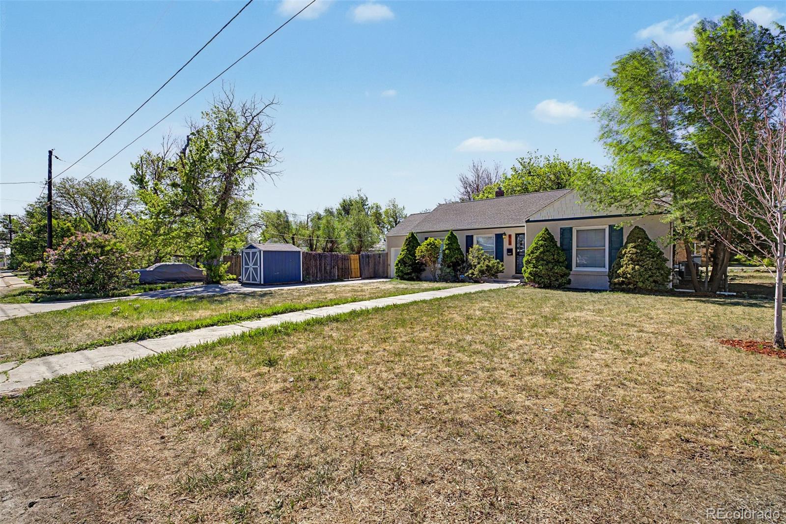 6790 West 48th Avenue Wheat Ridge, CO 80033 - Photo 3 of 30 a house with trees in the background