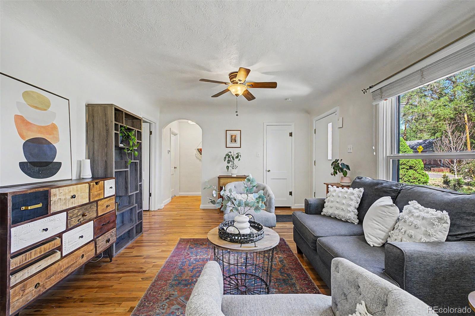 6790 West 48th Avenue Wheat Ridge, CO 80033 - Photo 5 of 30 a living room with furniture and a large window
