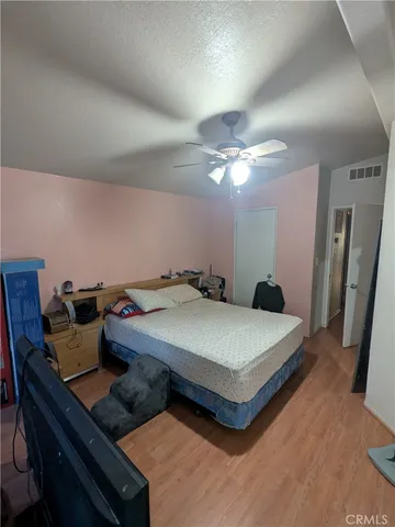 a bed sitting in a bedroom and chandelier