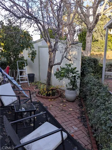 a view of a backyard with plants and outdoor seating