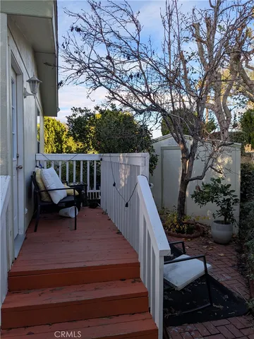 a view of balcony with wooden floor and outdoor seating
