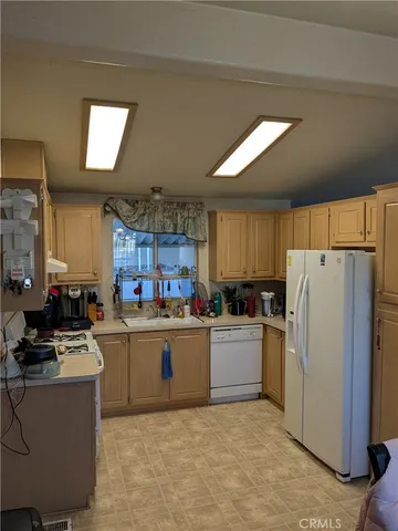 a kitchen with refrigerator and cabinets