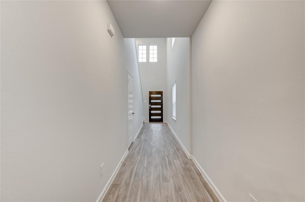 94 Valiant Ridge Trail Magnolia, TX 77354 - Photo 6 of 13 a view of a hallway with wooden floor and entryway