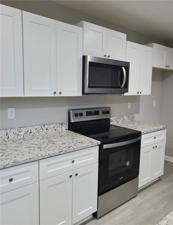 430 Arlington Lane Commerce, GA 30529 - Photo 1 of 1 a kitchen with stainless steel appliances granite countertop grey cabinets a stove a sink and dishwasher