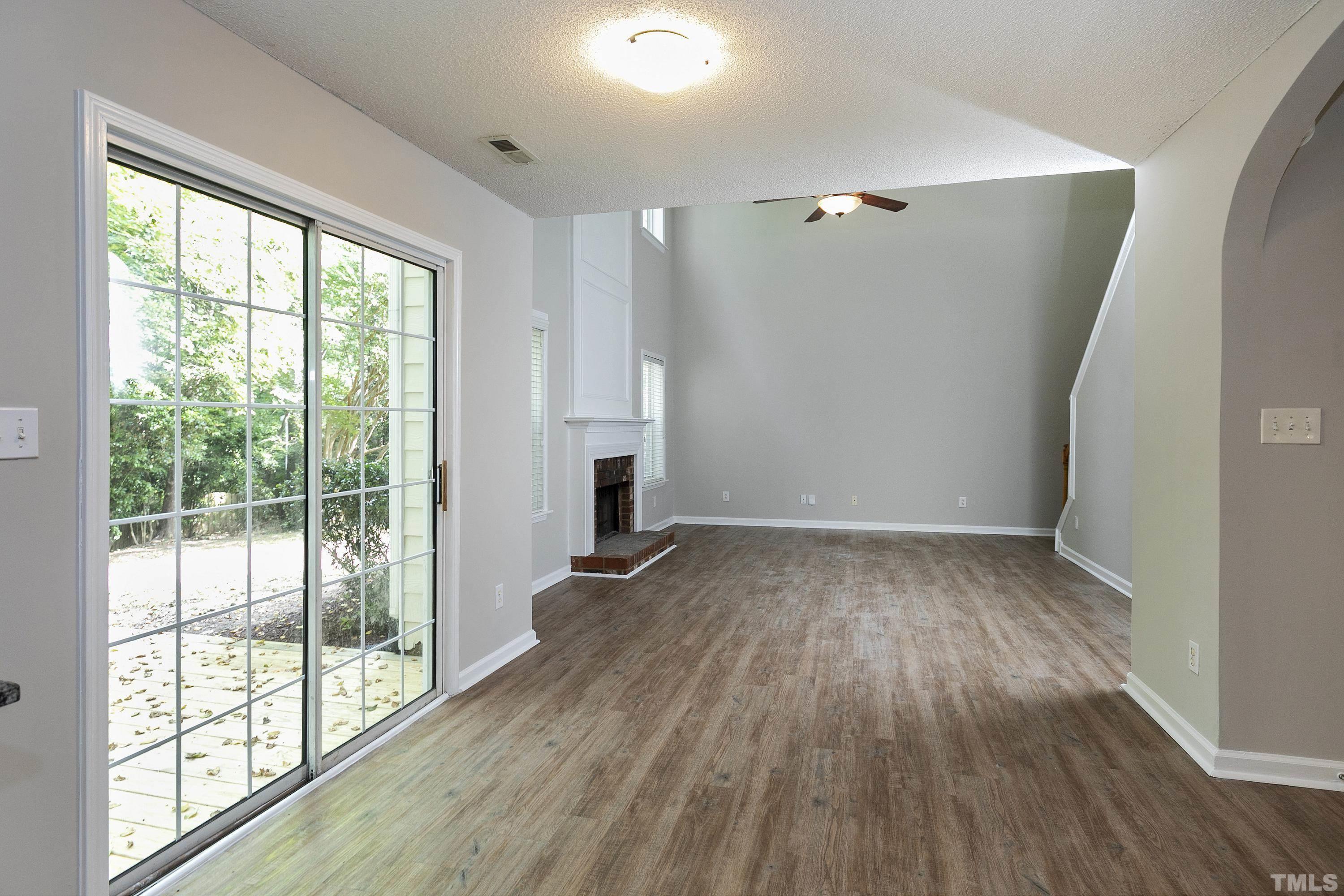 613 Branchview Drive Durham, NC 27713 - Photo 11 of 40 an empty room with wooden floor and windows