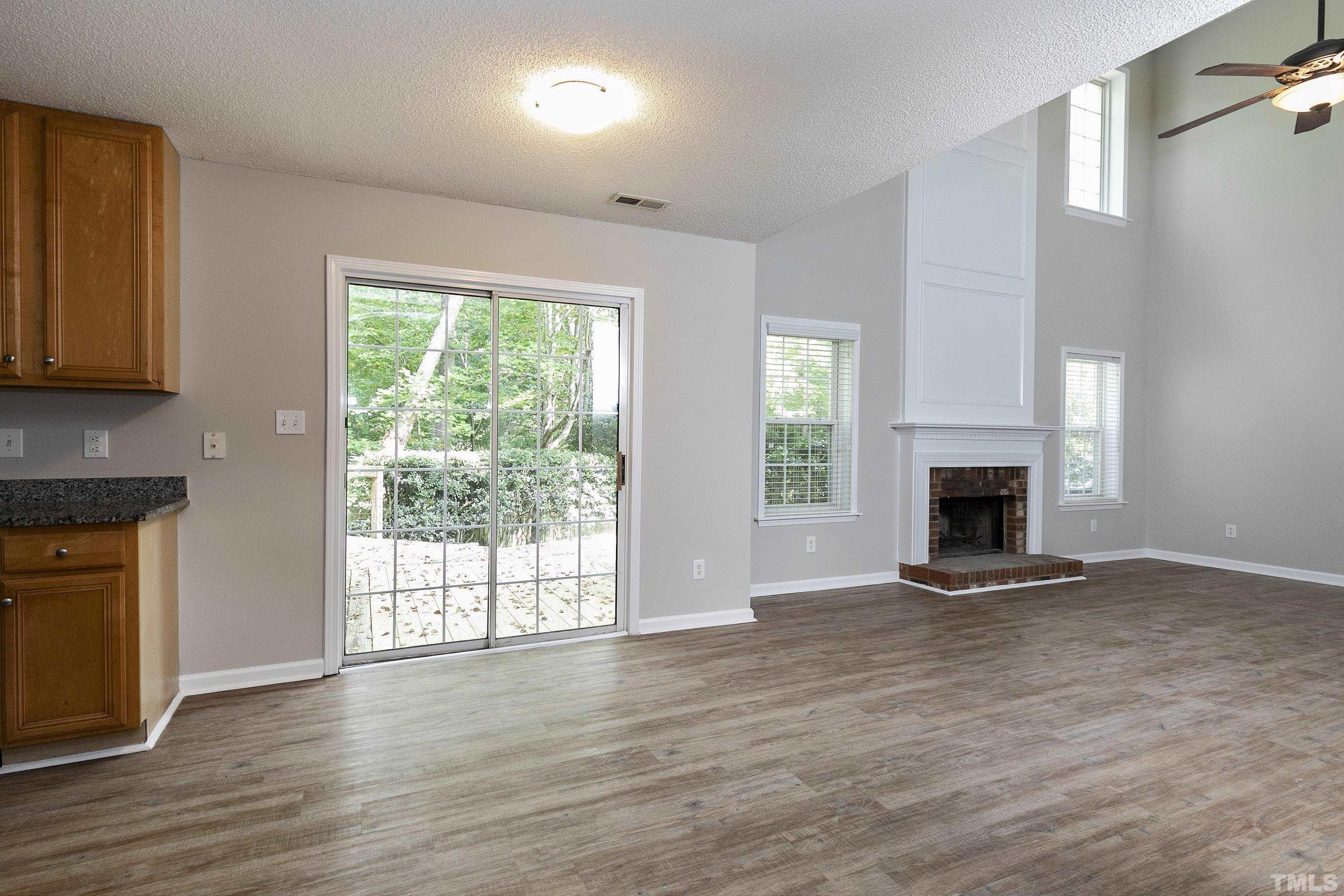 613 Branchview Drive Durham, NC 27713 - Photo 12 of 40 a view of an empty room with wooden floor and a window