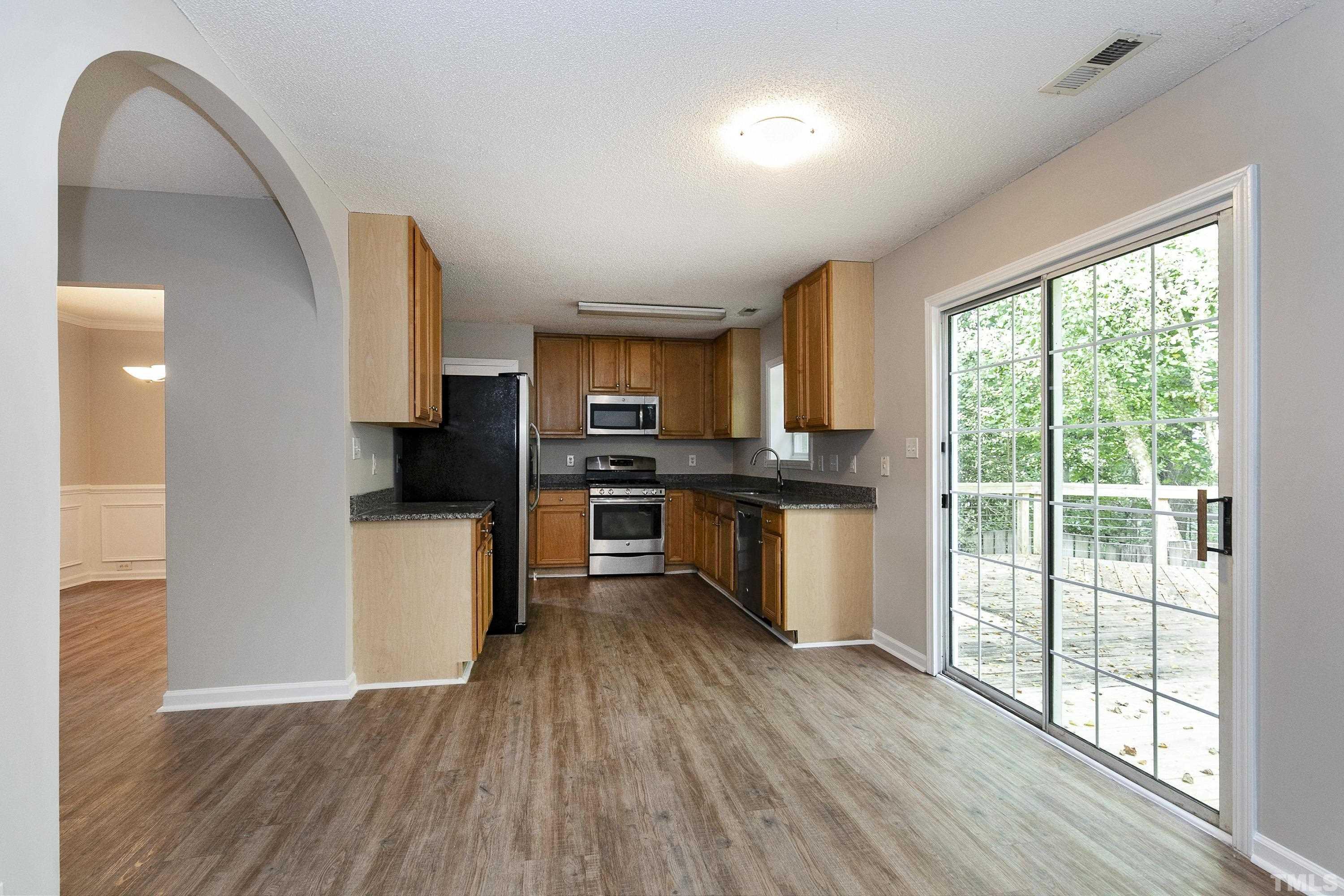 613 Branchview Drive Durham, NC 27713 - Photo 13 of 40 a kitchen with stainless steel appliances a refrigerator sink and cabinets