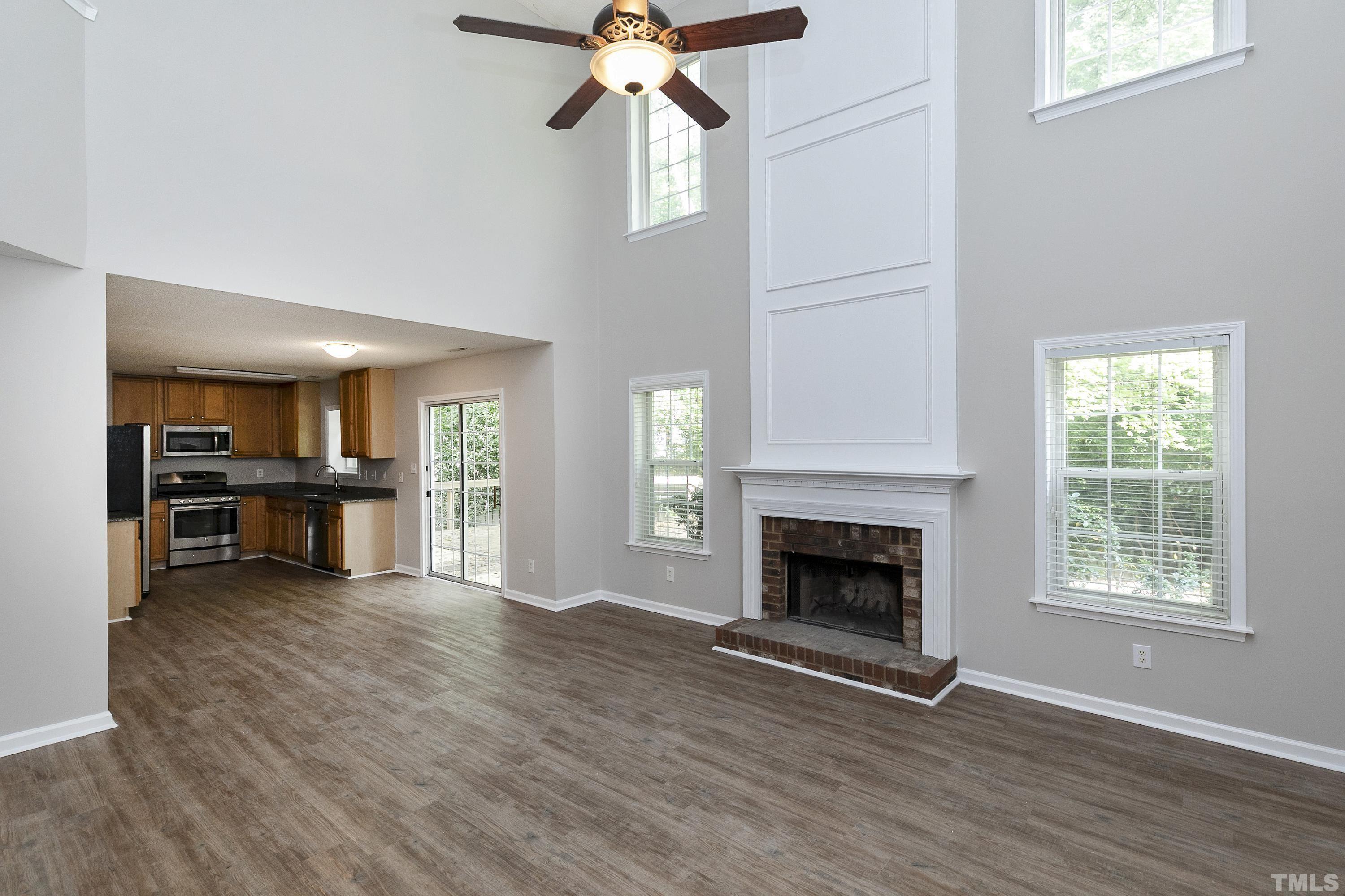 613 Branchview Drive Durham, NC 27713 - Photo 17 of 40 a view of an empty room with wooden floor fireplace and a window