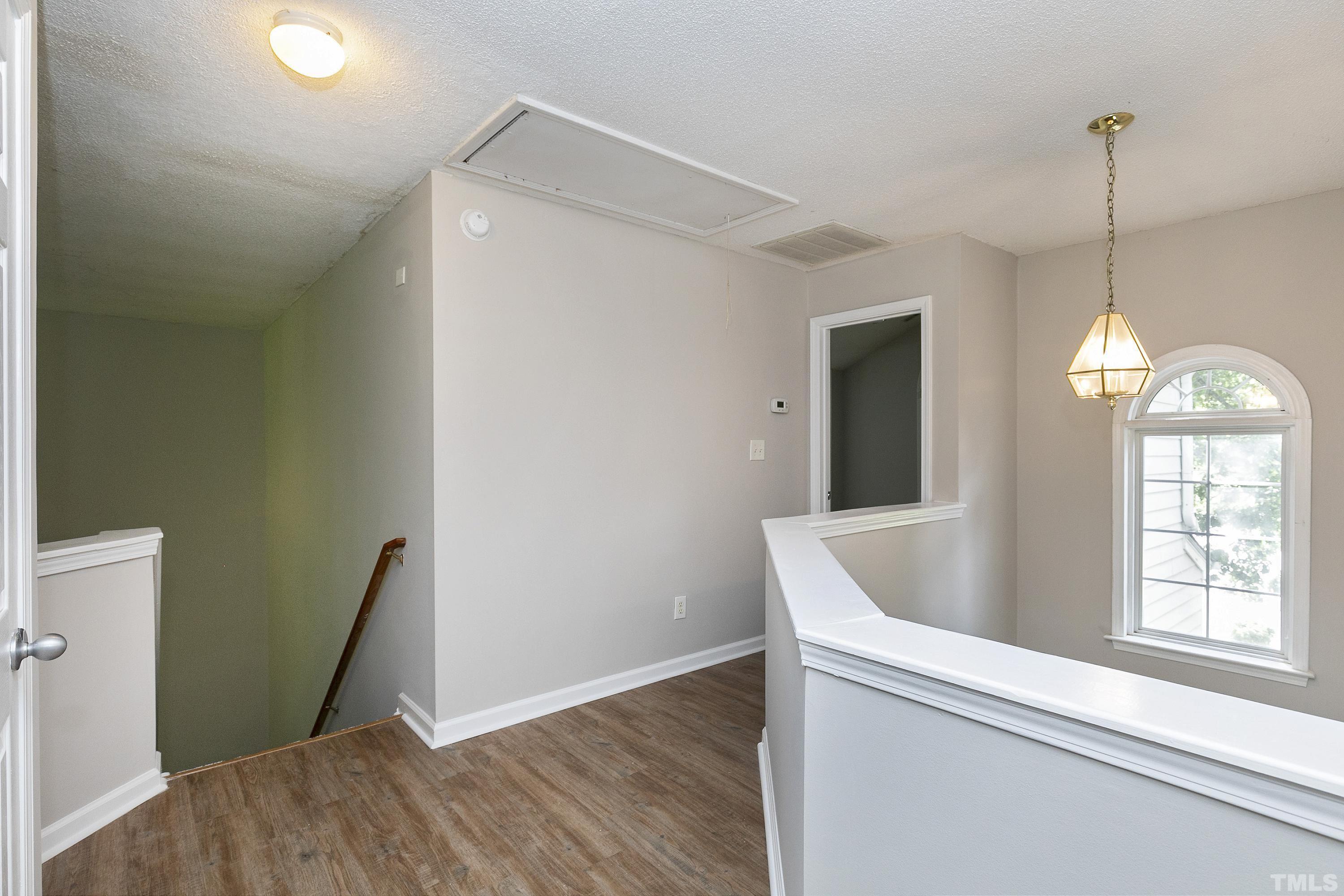 613 Branchview Drive Durham, NC 27713 - Photo 20 of 40 a view of hallway with window and wooden floor