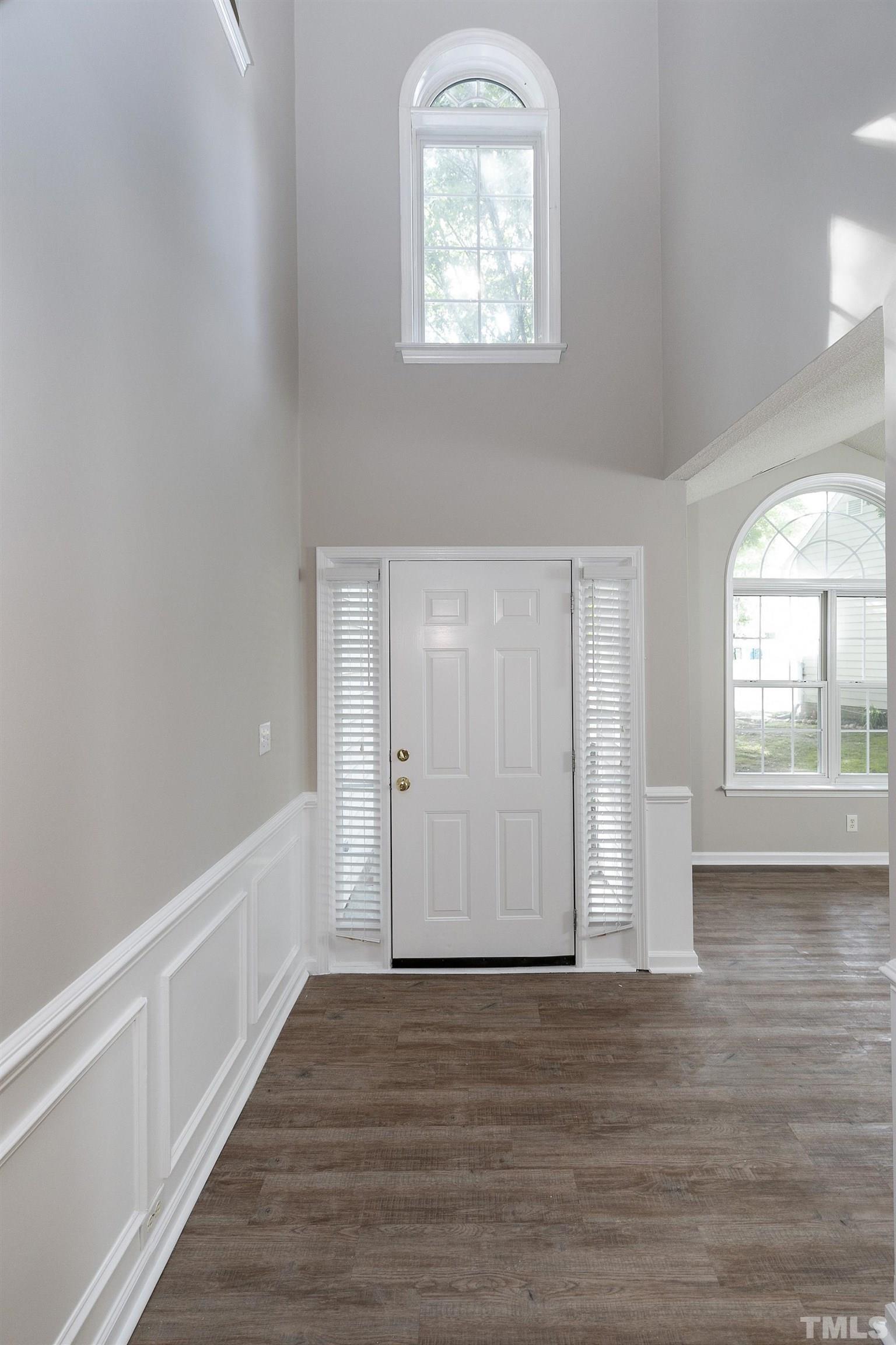 613 Branchview Drive Durham, NC 27713 - Photo 2 of 40 a view of an empty room with wooden floor and a window