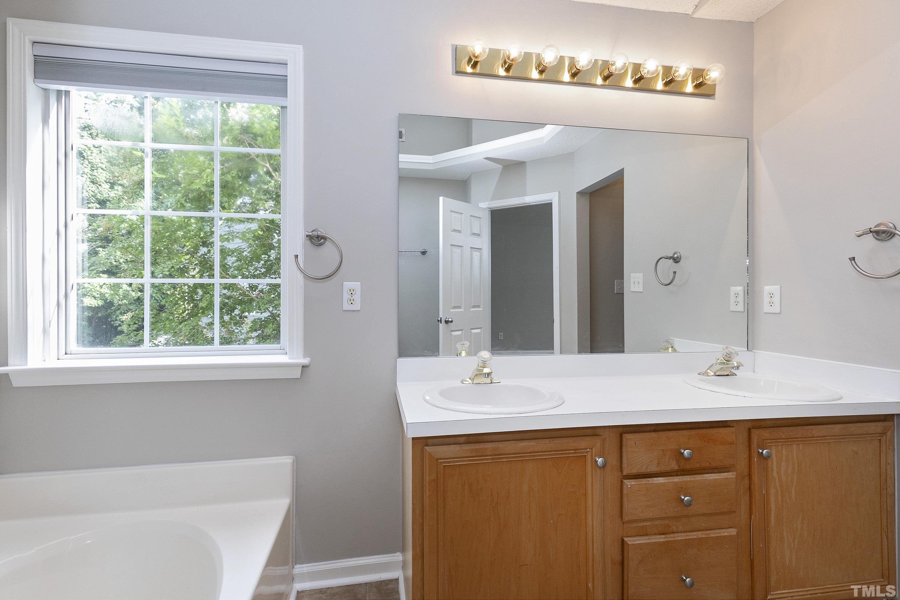 613 Branchview Drive Durham, NC 27713 - Photo 24 of 40 a bathroom with a sink double vanity and a mirror