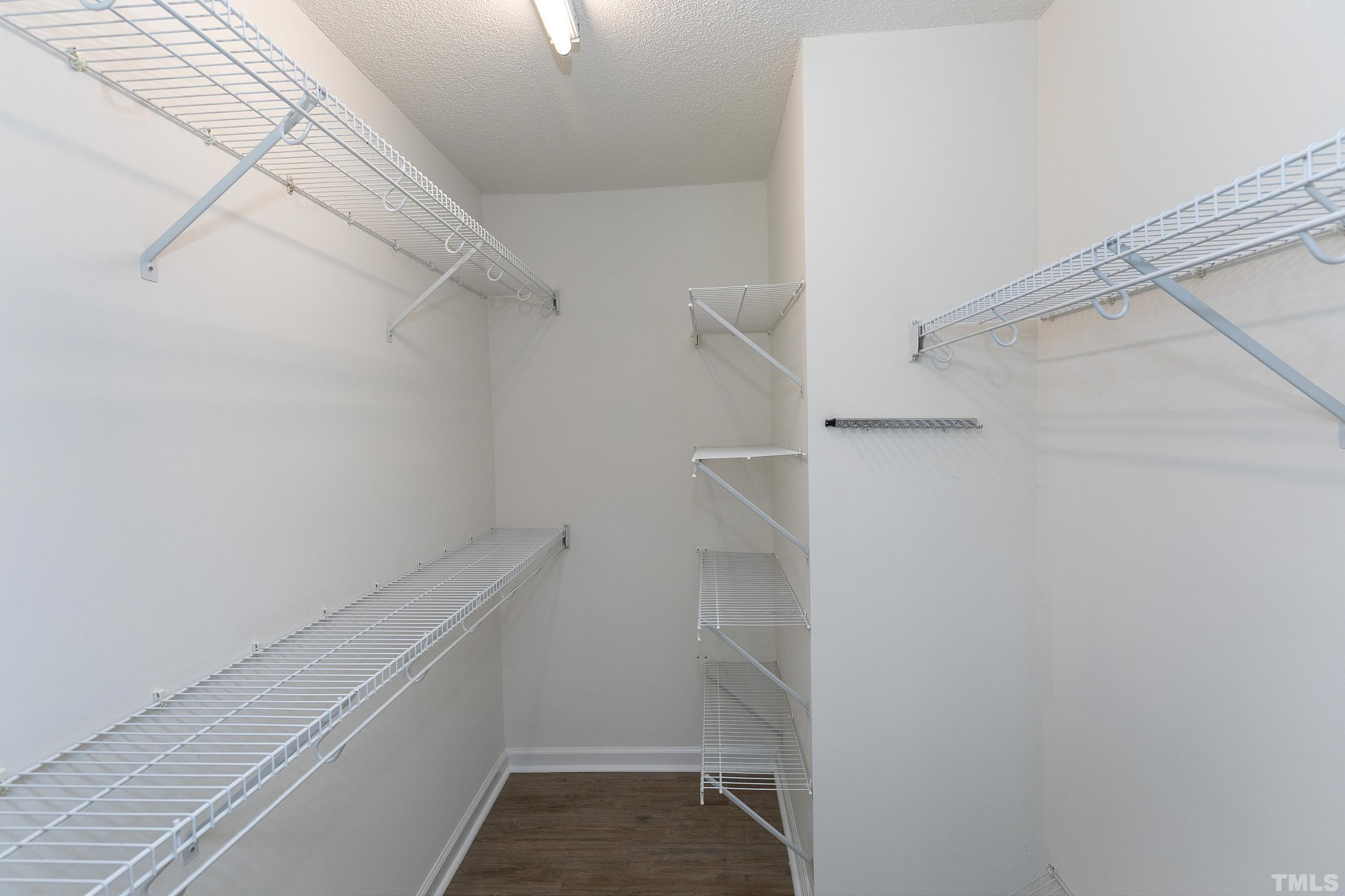 613 Branchview Drive Durham, NC 27713 - Photo 26 of 40 a view of walk in closet with empty racks