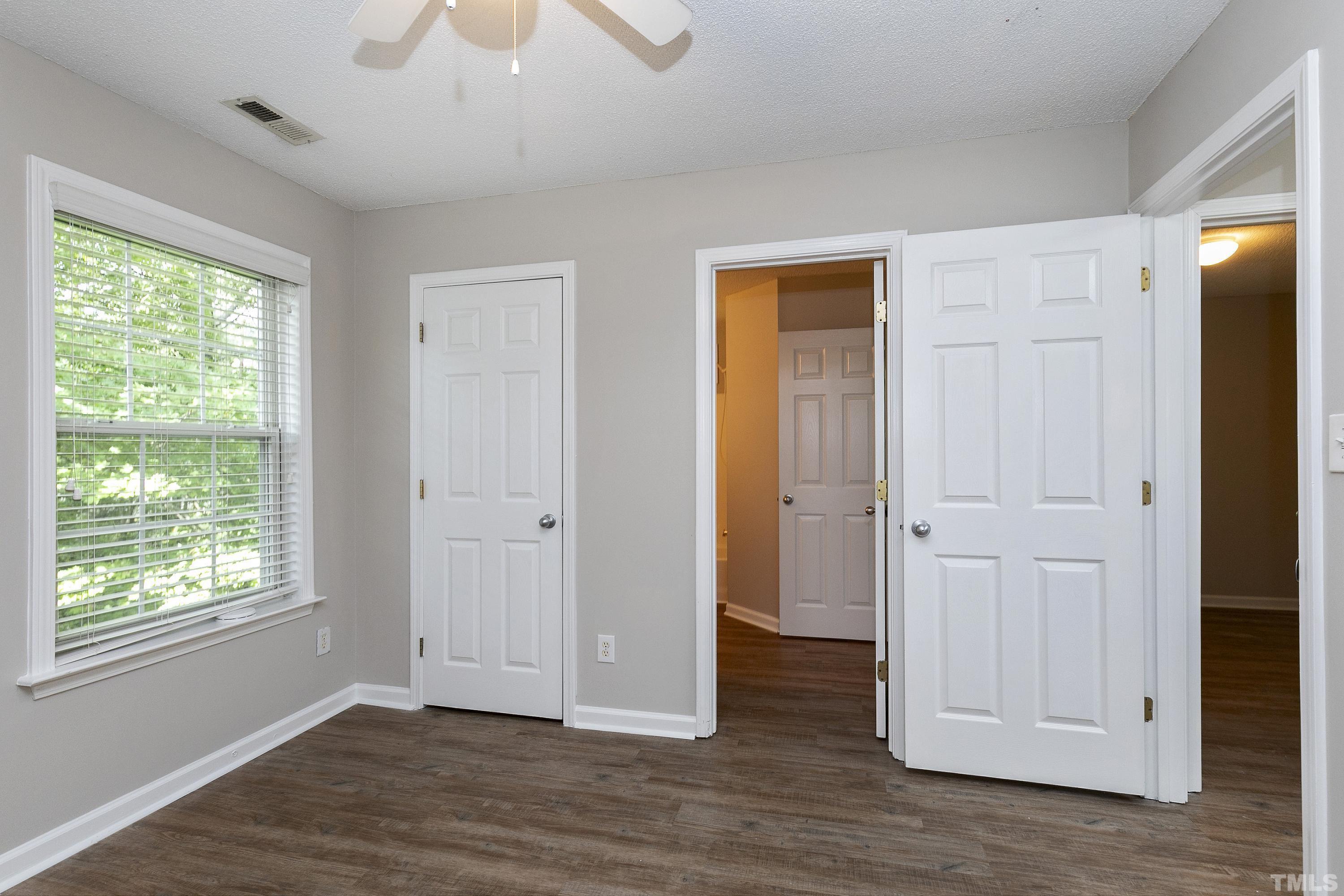 613 Branchview Drive Durham, NC 27713 - Photo 28 of 40 a view of an empty room with wooden floor and a window