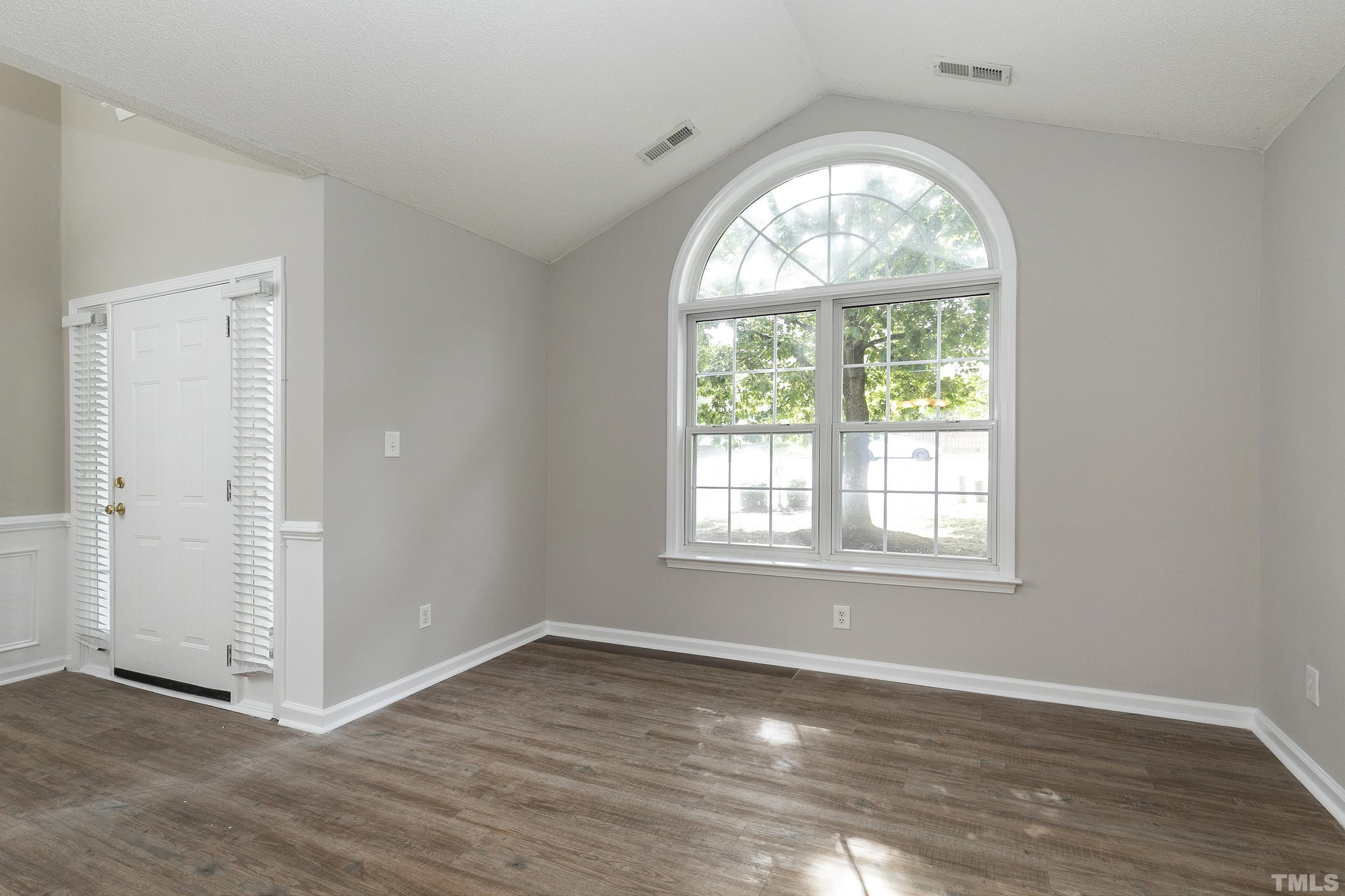 613 Branchview Drive Durham, NC 27713 - Photo 3 of 40 an empty room with wooden floor windows and entrance