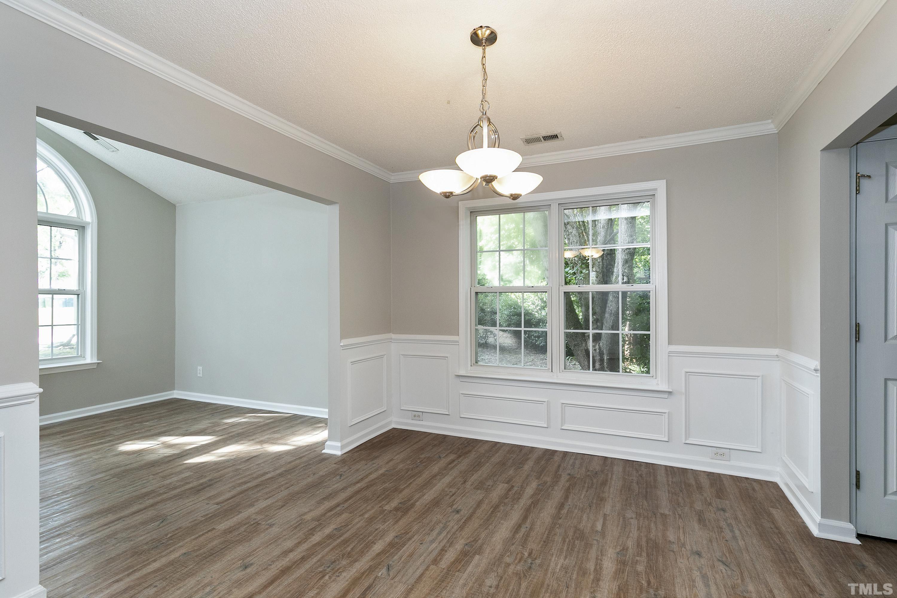 613 Branchview Drive Durham, NC 27713 - Photo 5 of 40 a view of an empty room with wooden floor and a window