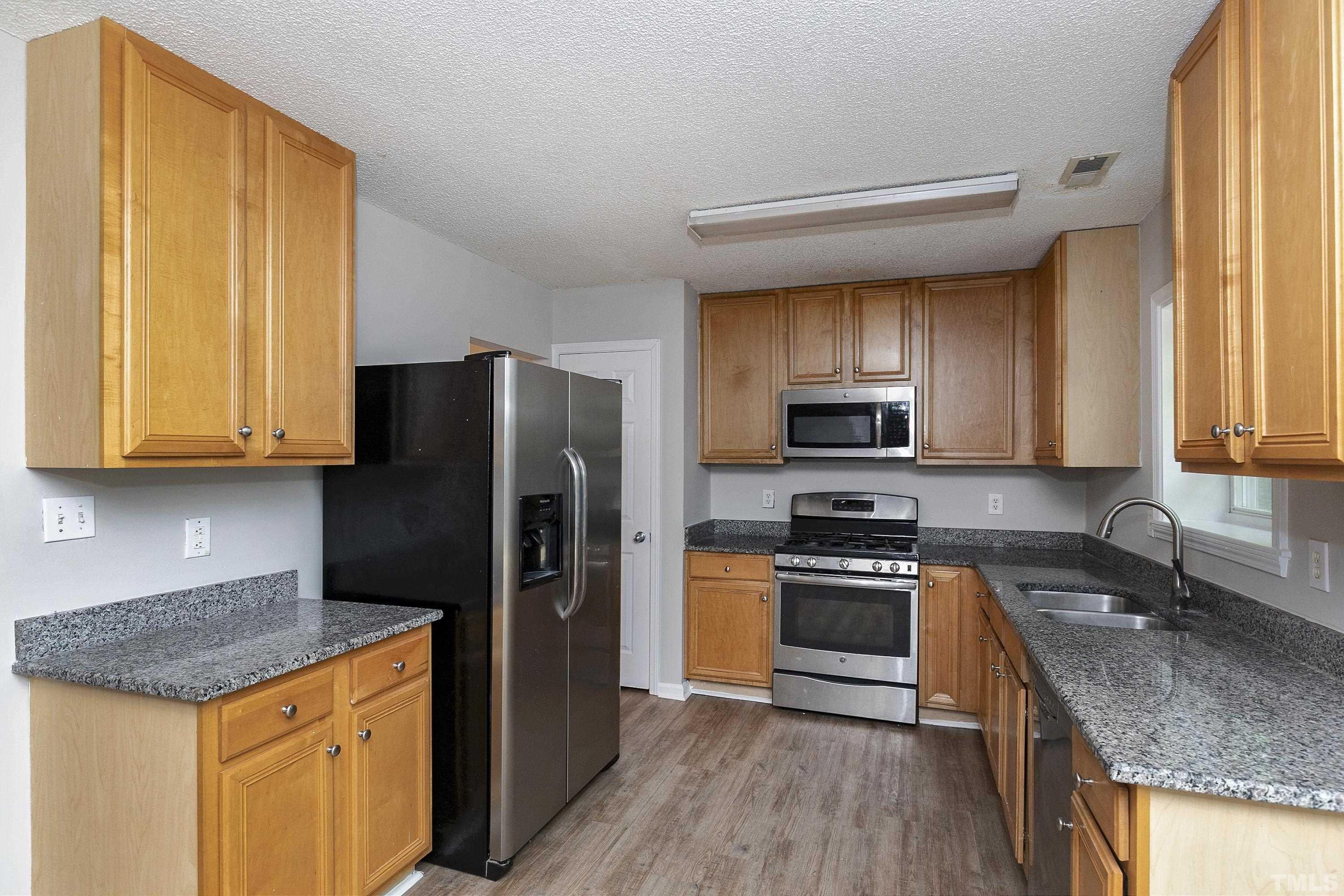 613 Branchview Drive Durham, NC 27713 - Photo 8 of 40 a kitchen with a refrigerator sink and microwave