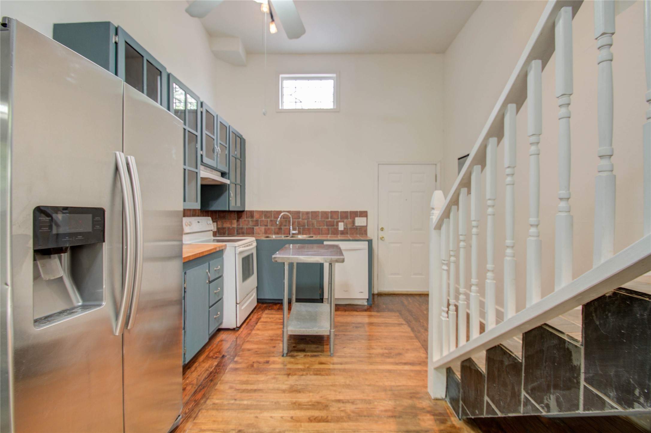 5311 Palmetto Street, Unit C Houston, TX 77081 - Photo 4 of 20 a kitchen with stainless steel appliances kitchen island wooden cabinets and entryway