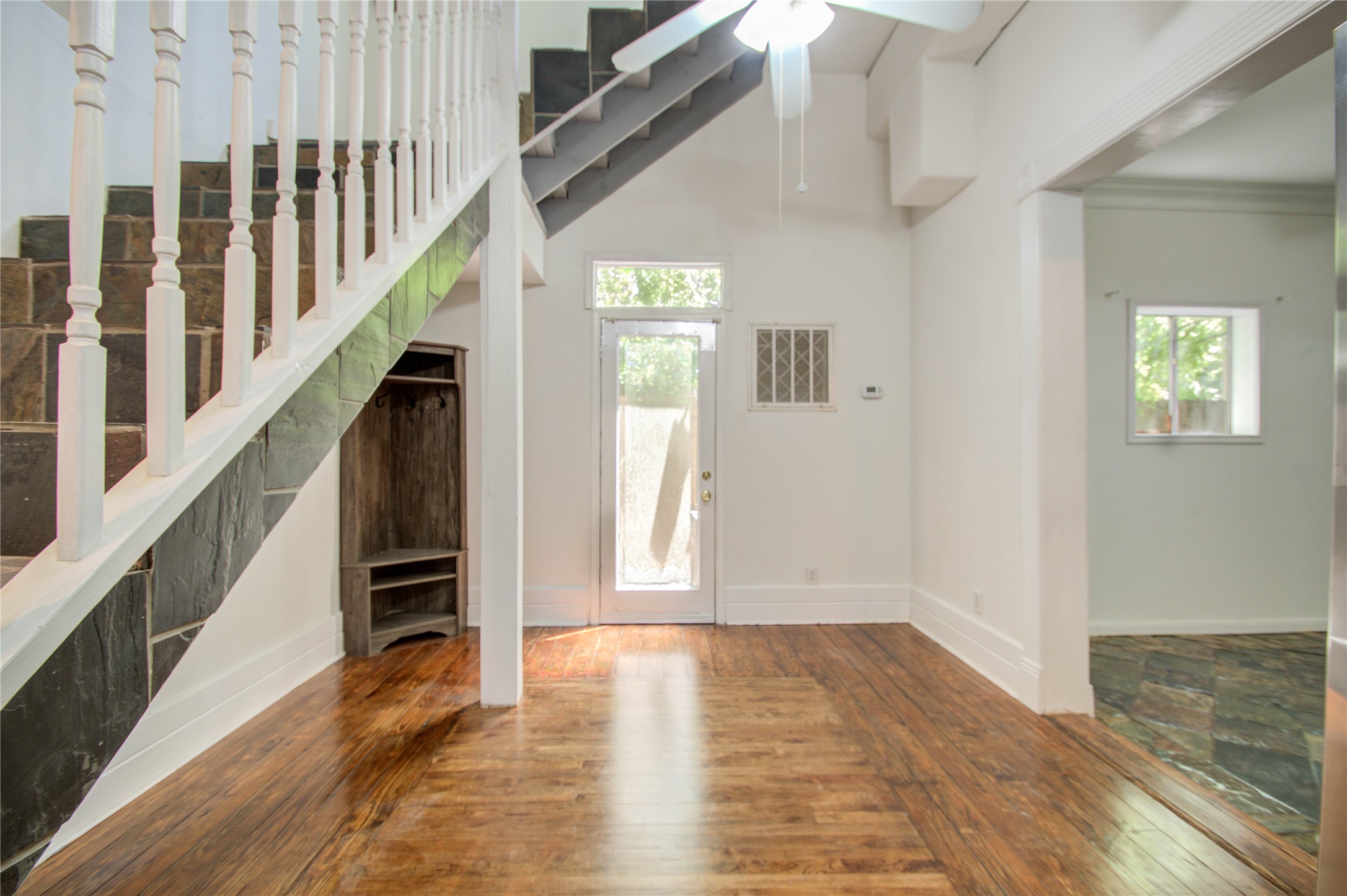 5311 Palmetto Street, Unit C Houston, TX 77081 - Photo 5 of 20 a view of an entryway with wooden floor and stairs
