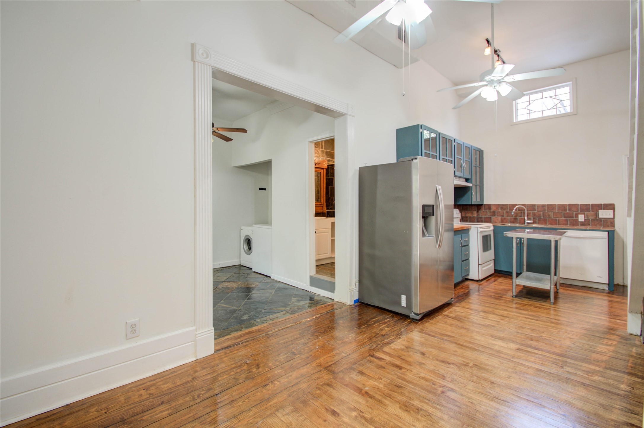 5311 Palmetto Street, Unit C Houston, TX 77081 - Photo 6 of 20 a view of a kitchen with wooden floor and a refrigerator